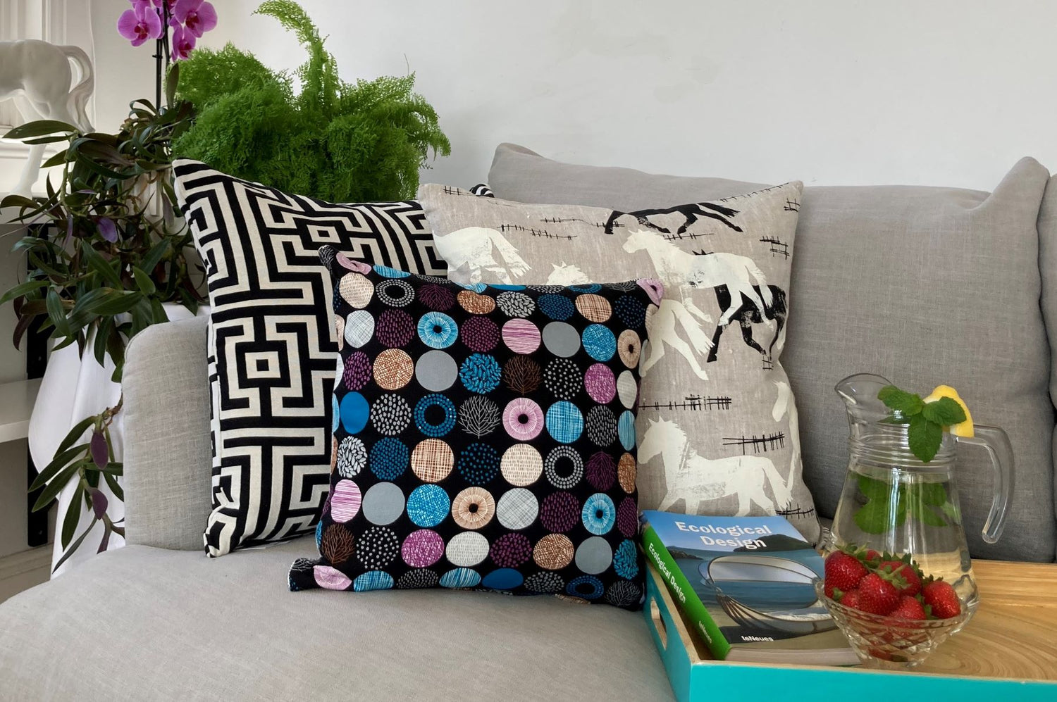 photo of beautifully styled cushions in blacks, whites with pops of colour