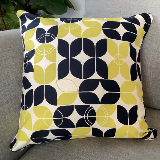 Side one of arches and triangle cushion cover on a couch