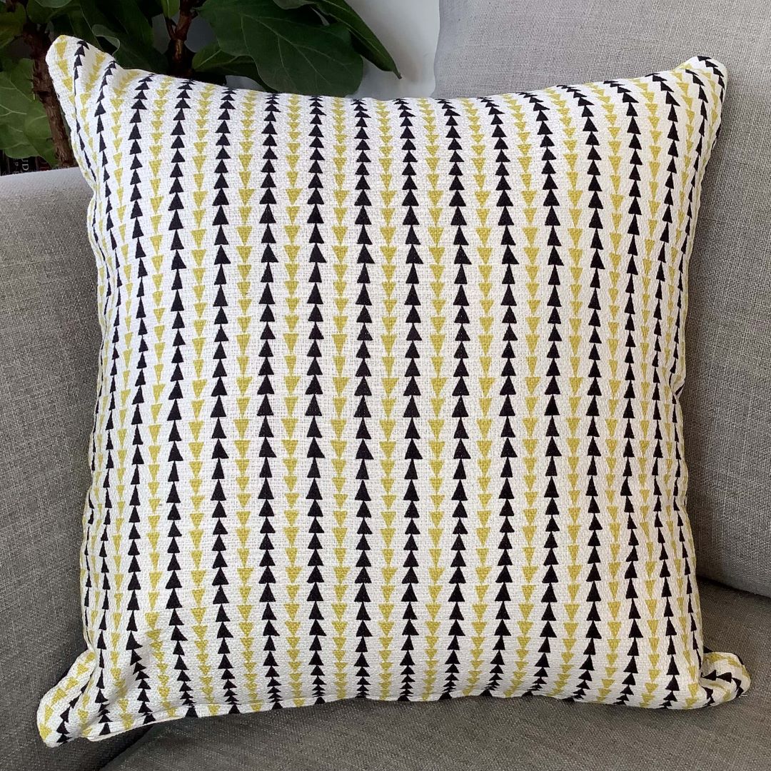 Side two of arches and triangle cushion cover on a couch