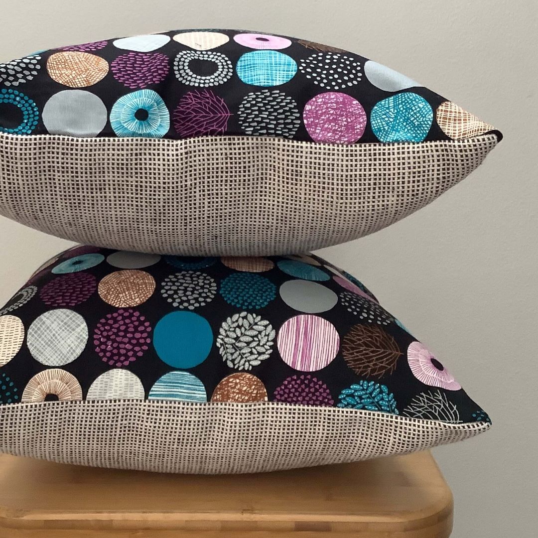 stacked circles of nature cushion covers showing front and back