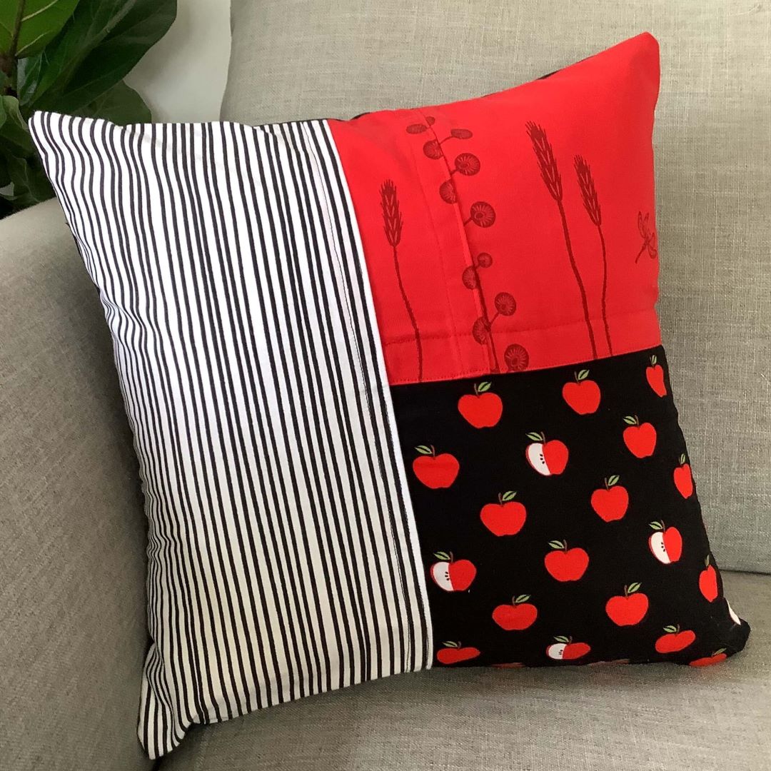 Apples and Lines cushion cover on a couch