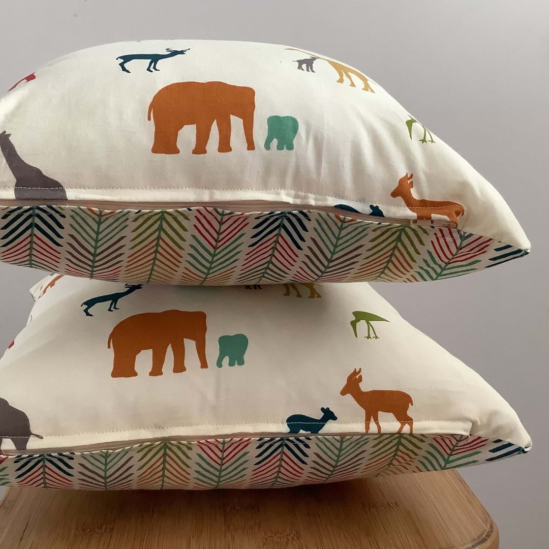 Stacked view of Out of Africa cushion cover showing zip detail and back and front fabric