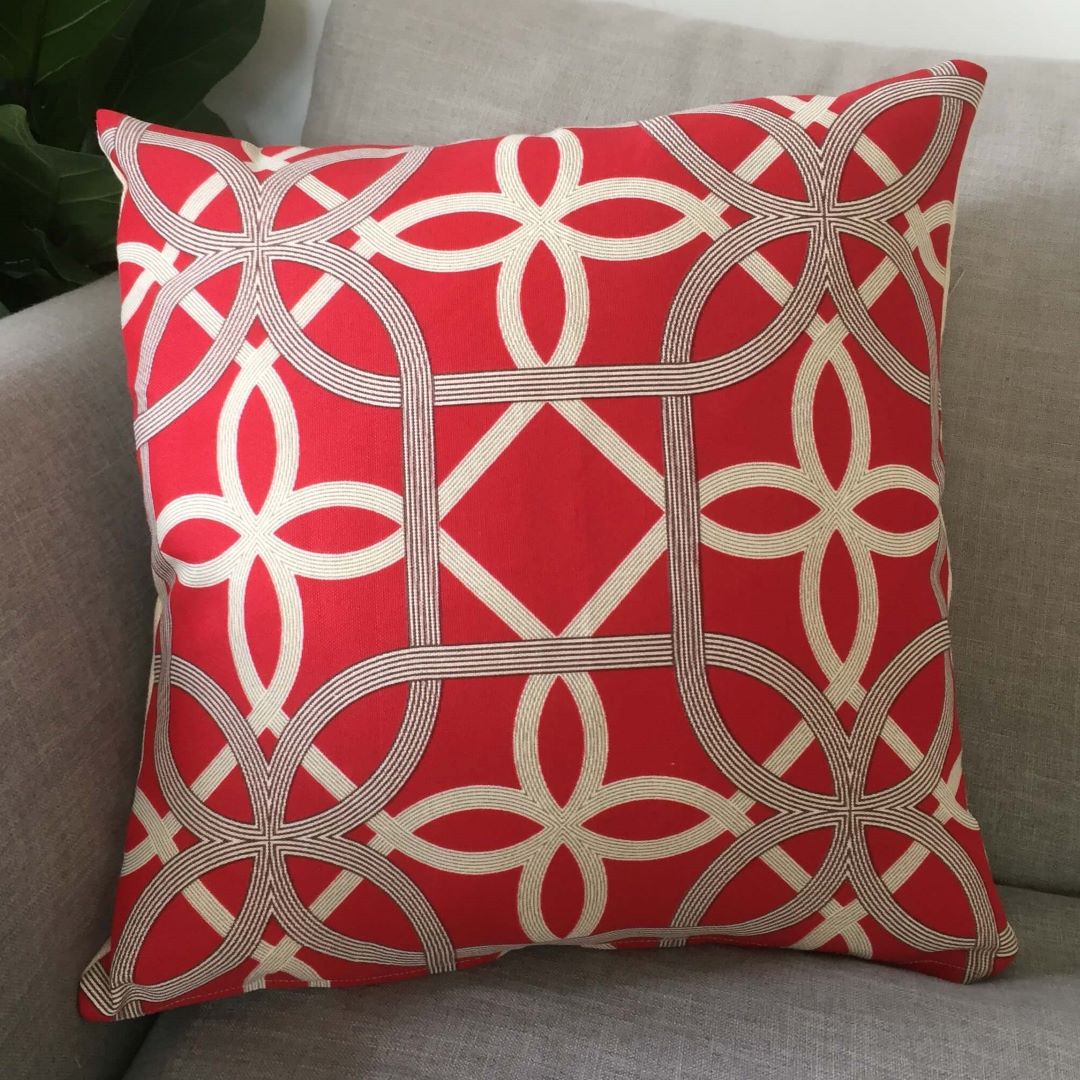 Red geometric cushion cover on couch