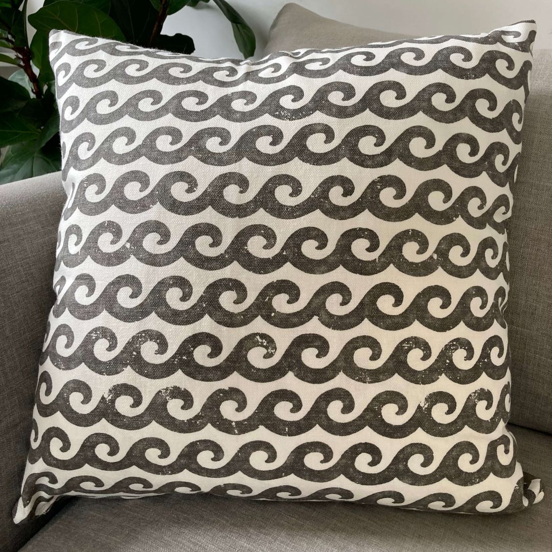 Waves and Swirls cushion cover, showing waves, on a couch