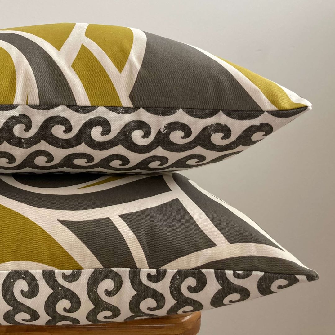 Stacked view of Waves and Swirls cushion covers showing both sides