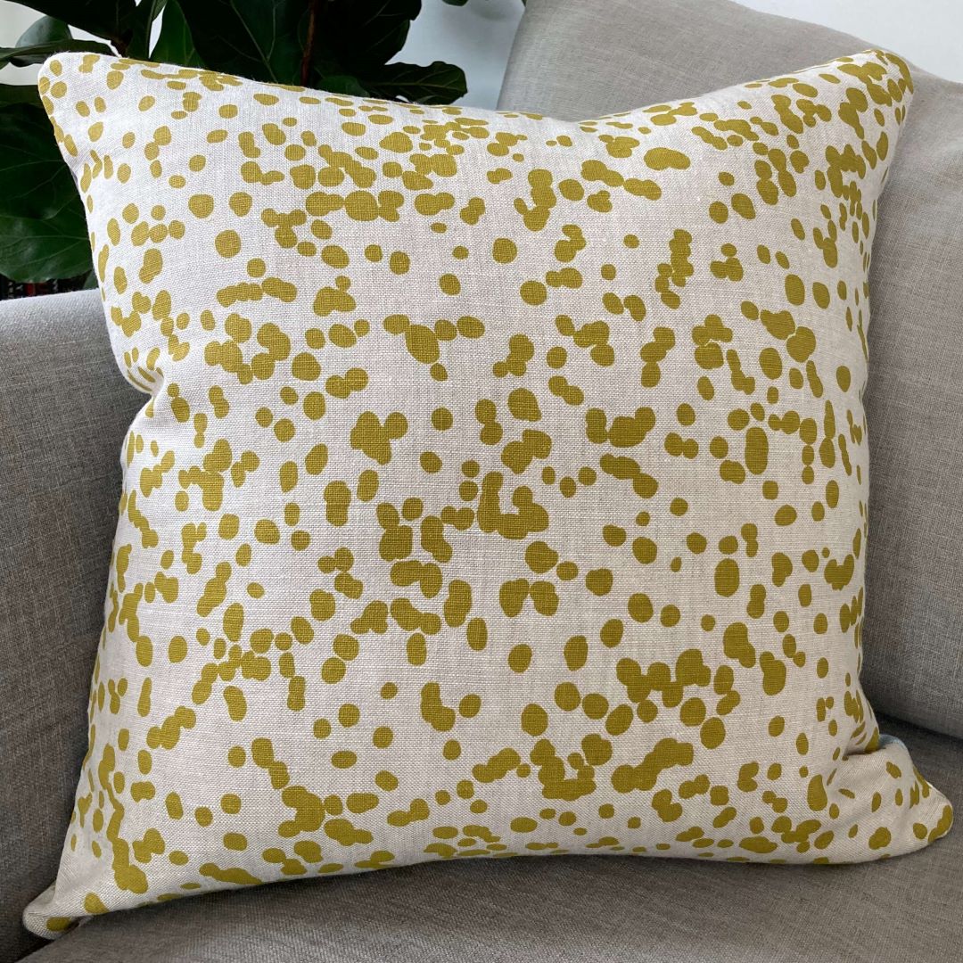 Spots side of spots and triangles cushion cover on a couch