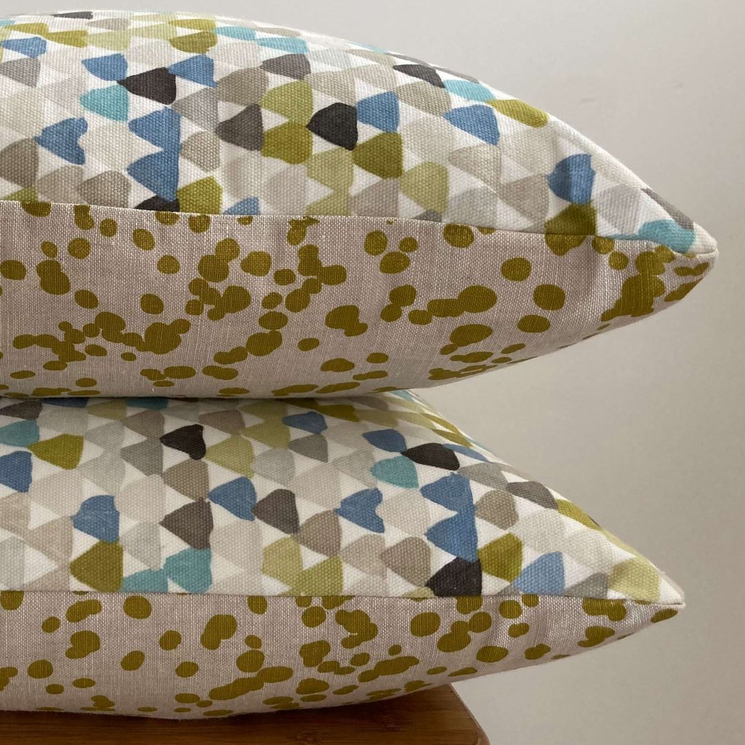 Stacked view of spots and triangles cushion covers showing front and back