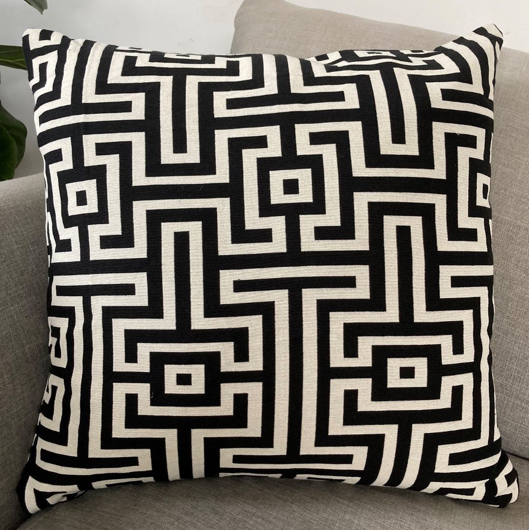 Black and white geometric cushion cover on a couch