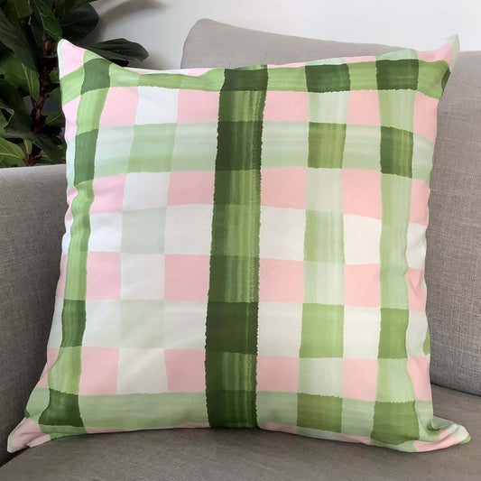 Gingham cushion cover in olive and pink on couch