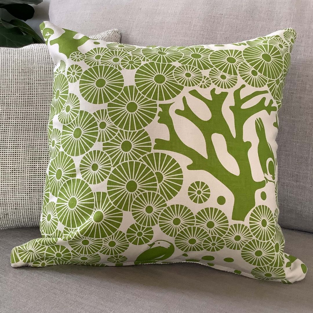 two 'Mikko' cushion covers in lime green showing front and back