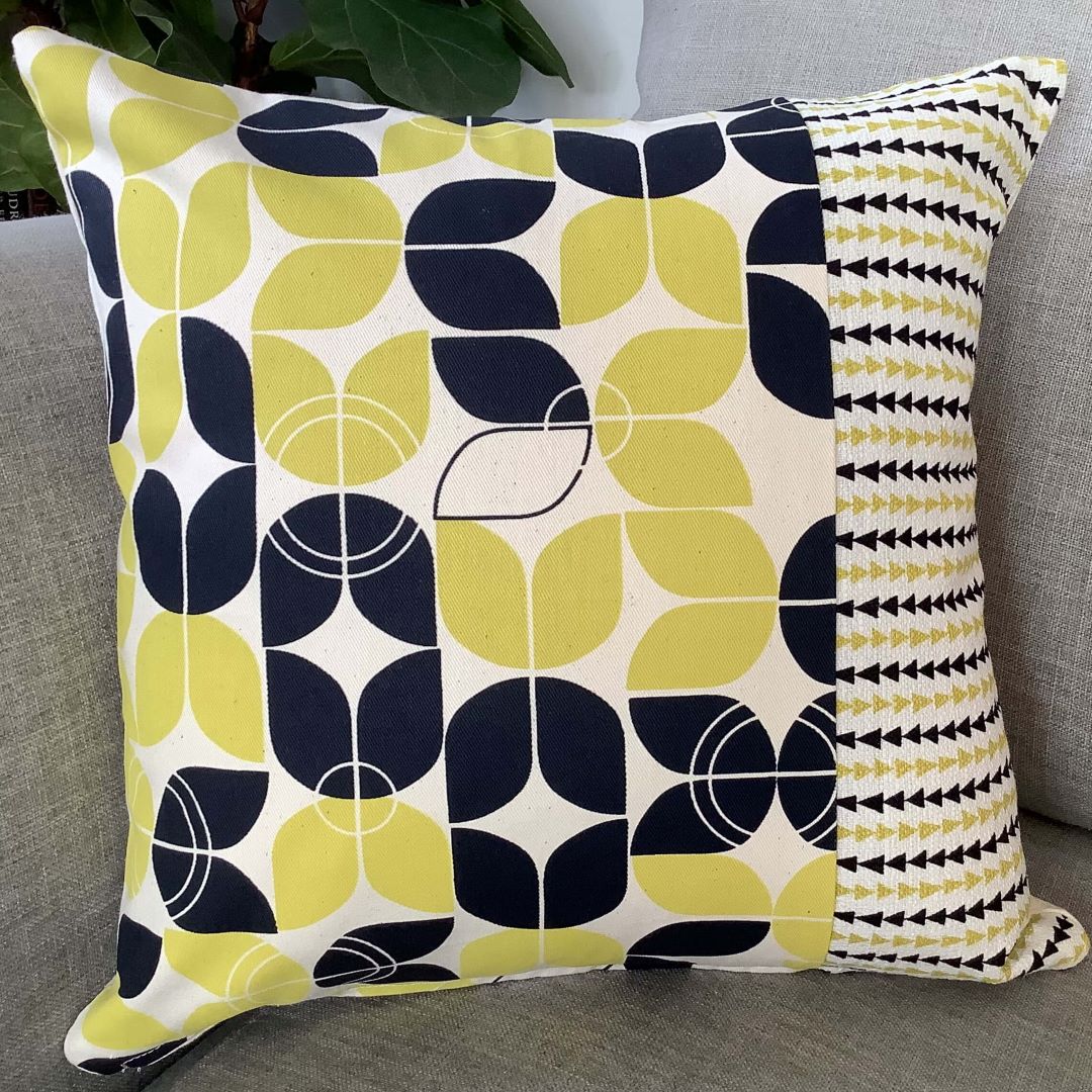 large and small geometrics cushion cover on a couch