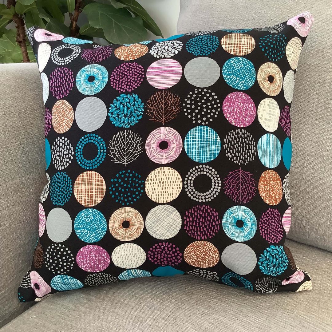 Circles of nature cushion cover on a couch